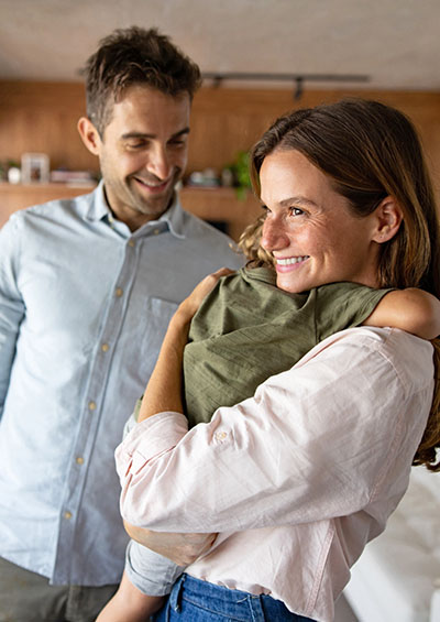 A young, happy couple with a child