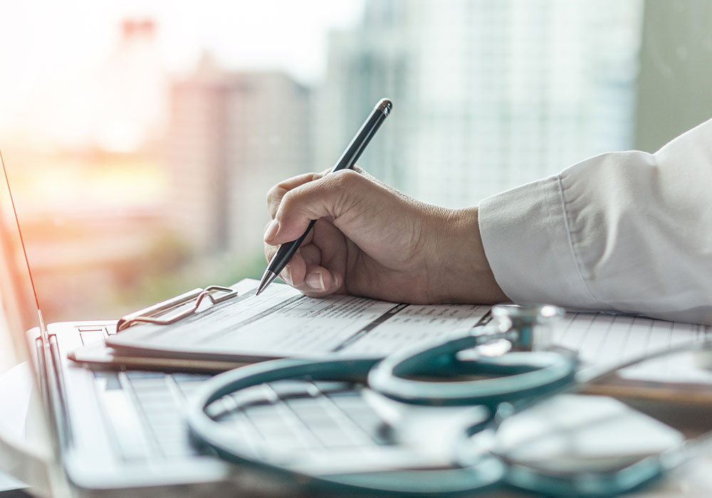 A self-employed doctor fills out forms